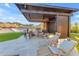 Stylish outdoor kitchen boasts a modern grill, seating, and views of the lush landscaping at 297 W Chase St, San Tan Valley, AZ 85143