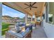 Inviting covered patio with comfortable seating and a view of the pool and desert landscape at 297 W Chase St, San Tan Valley, AZ 85143