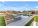 Relaxing poolside view with comfortable lounge chairs, a shimmering pool, and a desert landscape at 297 W Chase St, San Tan Valley, AZ 85143