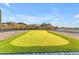 Backyard putting green showcasing immaculate turf and scenic views at 297 W Chase St, San Tan Valley, AZ 85143