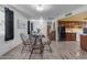 Bright dining area featuring laminate floors and a modern table set at 330 W Northern Ave, Coolidge, AZ 85128