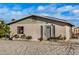 Charming single-story home showcasing a gravel front yard, cozy front porch and neutral color palette at 330 W Northern Ave, Coolidge, AZ 85128