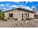 Charming single-story home showcasing a gravel front yard, cozy front porch and neutral color palette at 330 W Northern Ave, Coolidge, AZ 85128