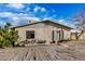 Charming single-story home showcasing a gravel front yard, cozy front porch and neutral color palette at 330 W Northern Ave, Coolidge, AZ 85128