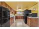 Functional kitchen with wood cabinets, white appliances, and ample counter space at 330 W Northern Ave, Coolidge, AZ 85128