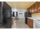 Kitchen space leading into a dining area, featuring wood cabinets and laminate floors at 330 W Northern Ave, Coolidge, AZ 85128