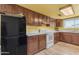 Well-equipped kitchen with wood cabinets and white appliances at 330 W Northern Ave, Coolidge, AZ 85128