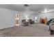 Open living room featuring neutral carpet, natural light and comfortable seating arrangement at 330 W Northern Ave, Coolidge, AZ 85128