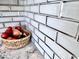 Close-up of a decorative backsplash with grey tile accents and countertop basket at 3328 W Charter Oak Rd, Phoenix, AZ 85029