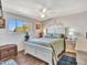 Cozy bedroom with a ceiling fan and a view of the outdoors, creating a comfortable and inviting atmosphere at 3328 W Charter Oak Rd, Phoenix, AZ 85029