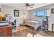 Well-lit bedroom with a ceiling fan, natural light, and stylish décor at 3328 W Charter Oak Rd, Phoenix, AZ 85029