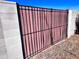 Exterior side gate with black metal and privacy slats set into block wall at 3328 W Charter Oak Rd, Phoenix, AZ 85029