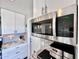 Well-lit kitchen featuring white cabinets, stainless steel microwave, and stylish countertops at 3328 W Charter Oak Rd, Phoenix, AZ 85029