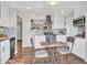 Bright kitchen featuring stainless steel appliances, white cabinetry, and an adjacent dining area at 3328 W Charter Oak Rd, Phoenix, AZ 85029