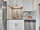 Close-up of kitchen sink, faucet, and backsplash, featuring modern design elements at 3328 W Charter Oak Rd, Phoenix, AZ 85029