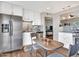 Bright kitchen featuring stainless steel appliances, white cabinetry, and an adjacent dining area at 3328 W Charter Oak Rd, Phoenix, AZ 85029