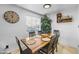 Well-lit dining room with a wooden table, seating for six, and a decorative clock at 3331 W Sells Dr, Phoenix, AZ 85017