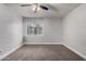 Bright bedroom features a ceiling fan, window with blinds, neutral carpeting, and white trim at 3416 N 44Th St # 70, Phoenix, AZ 85018