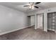 Bedroom features a ceiling fan, large closet with mirrored doors, neutral colored carpet, and white trim at 3416 N 44Th St # 70, Phoenix, AZ 85018