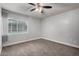 Bedroom features a ceiling fan, window with blinds, and neutral carpeting at 3416 N 44Th St # 70, Phoenix, AZ 85018