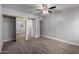 Bedroom includes a ceiling fan, large closet with mirrored doors, neutral colored carpet, and white trim at 3416 N 44Th St # 70, Phoenix, AZ 85018