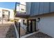 Condo exterior featuring a small balcony and basement-level doorway entrance and black metal banisters at 3416 N 44Th St # 70, Phoenix, AZ 85018