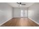 Open concept living room with wood floors, neutral paint, modern ceiling fan, and sliding doors to a patio at 3416 N 44Th St # 70, Phoenix, AZ 85018