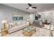 Inviting living room with white sofa, ceiling fan, and view into the open kitchen and dining area at 3416 N 44Th St # 70, Phoenix, AZ 85018