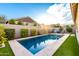 Serene backyard pool area with artificial turf and private block wall landscaping at 3519 E Appaloosa Rd, Gilbert, AZ 85296