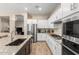 Modern kitchen featuring stainless appliances, white cabinets, and granite countertops at 3519 E Appaloosa Rd, Gilbert, AZ 85296