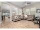 Bright living room with modern ceiling fan, tile flooring, and neutral-toned sofas at 3519 E Appaloosa Rd, Gilbert, AZ 85296