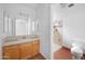 Bright bathroom with single vanity, mirrored cabinet, and tiled shower; a clean and functional space at 3545 N Hohokam Dr, Eloy, AZ 85131