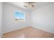 Bright bedroom features a ceiling fan, a large window, and light colored wood floors at 3545 N Hohokam Dr, Eloy, AZ 85131