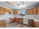 Kitchen with wood cabinetry, white appliances, a white backsplash and tile flooring at 3545 N Hohokam Dr, Eloy, AZ 85131