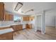 Kitchen with wood cabinetry, white appliances, a white backsplash and tile flooring at 3545 N Hohokam Dr, Eloy, AZ 85131