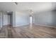 Spacious living room with wood-look flooring, modern gray walls, and a ceiling fan is ideal for gatherings at 3545 N Hohokam Dr, Eloy, AZ 85131