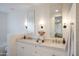 Bright bathroom with double vanity, stone counter tops, and brass hardware at 35530 N Canyon Crossings Dr, Carefree, AZ 85377