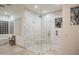 Bright walk-in shower with white tile, glass surround and travertine floors at 35530 N Canyon Crossings Dr, Carefree, AZ 85377