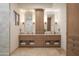 Elegant bathroom featuring double vanity sinks with granite countertops and wooden cabinets at 35530 N Canyon Crossings Dr, Carefree, AZ 85377