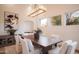 Comfortable dining room area with a wood dining table and seating for six, featuring a chandelier at 35530 N Canyon Crossings Dr, Carefree, AZ 85377