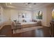 Bright living room featuring a large sectional sofa, wooden floors, and natural light from the large window at 35530 N Canyon Crossings Dr, Carefree, AZ 85377