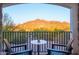 Relaxing balcony with Adirondack chairs offering stunning views of the surrounding desert landscape at 35530 N Canyon Crossings Dr, Carefree, AZ 85377