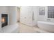 Bathroom featuring soaking tub, glass block window, and fireplace at 35530 N Canyon Crossings Dr, Cave Creek, AZ 85331