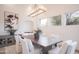 Bright dining room features a modern chandelier and white upholstered chairs around a wooden table at 35530 N Canyon Crossings Dr, Cave Creek, AZ 85331