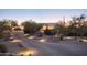 Desert home featuring a circular design, front-facing garage, and lighted brick driveway at 35530 N Canyon Crossings Dr, Carefree, AZ 85377