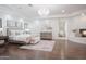 Spacious main bedroom featuring a fireplace, wood floors, chandelier, and ensuite access at 35530 N Canyon Crossings Dr, Cave Creek, AZ 85331