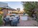 Inviting outdoor kitchen and dining area with built-in grill, umbrella-covered table, and lush landscaping at 35530 N Canyon Crossings Dr, Cave Creek, AZ 85331