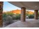 Covered outdoor patio with stone pillars and desert views at 35530 N Canyon Crossings Dr, Cave Creek, AZ 85331