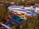 Aerial view of a backyard oasis featuring a sparkling pool, spa, and covered outdoor kitchen at 35530 N Canyon Crossings Dr, Carefree, AZ 85377