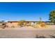 Charming single story home with desert landscaping and a gravel driveway under a clear blue sky at 417 W Sunset Dr, Mammoth, AZ 85618